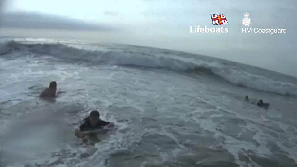 People struggling in the water at sea