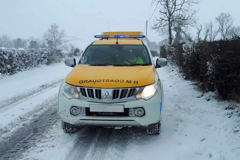 A Coastguard rescue vehicle driving in snowy conditions